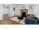 Comfortable living room with a brick fireplace, a couch, chair, and a decorative rug at 4003 Federal Blvd, Denver, CO 80211