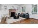 Bright living room featuring a fireplace, sofa, chair, and stylish decor at 4003 Federal Blvd, Denver, CO 80211