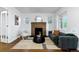 Bright living room featuring a brick fireplace, modern sofa, and stylish decor at 4003 Federal Blvd, Denver, CO 80211