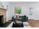 Inviting living room featuring a brick fireplace, comfortable sofa, and stylish accents at 4003 Federal Blvd, Denver, CO 80211