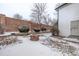 Spacious backyard features a brick fire pit and privacy fence at 12107 E Vassar Dr, Aurora, CO 80014