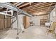 Unfinished basement space with exposed beams and concrete walls, offering potential for customization at 12107 E Vassar Dr, Aurora, CO 80014