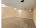 A finished basement offers versatile space, carpeted and ready for customization and relaxation at 12107 E Vassar Dr, Aurora, CO 80014