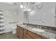 Bathroom features a granite-topped double vanity, large mirror, and shower showcasing a blend of style and functionality at 12107 E Vassar Dr, Aurora, CO 80014