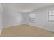 Spacious bedroom with carpet and a window allowing natural light to enter, highlighting the room's potential at 12107 E Vassar Dr, Aurora, CO 80014
