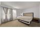 Cozy bedroom features a comfortable mattress, soft carpet, and a bright window for natural light at 12107 E Vassar Dr, Aurora, CO 80014
