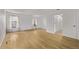 Spacious bedroom with hardwood floors, two windows, and an ensuite bathroom at 12107 E Vassar Dr, Aurora, CO 80014