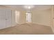 A carpeted bedroom with ample closet space and natural light offers comfort and functionality at 12107 E Vassar Dr, Aurora, CO 80014