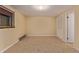 This carpeted bedroom is ready for personalization with a large window and neutral walls at 12107 E Vassar Dr, Aurora, CO 80014