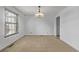Bright dining room featuring tile flooring, a window with blinds, and an elegant chandelier at 12107 E Vassar Dr, Aurora, CO 80014