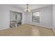 Inviting dining room with tile flooring, chandelier, and an open view to the kitchen and other rooms at 12107 E Vassar Dr, Aurora, CO 80014