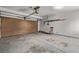 Spacious garage with a roll-up door, providing ample parking and storage solutions at 12107 E Vassar Dr, Aurora, CO 80014
