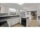 Well-lit kitchen featuring granite countertops, tile flooring, and stainless steel appliances at 12107 E Vassar Dr, Aurora, CO 80014