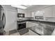 A kitchen featuring a microwave, range, granite countertops and tile flooring at 12107 E Vassar Dr, Aurora, CO 80014