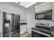 Functional kitchen featuring stainless steel appliances and ample cabinet space at 12107 E Vassar Dr, Aurora, CO 80014