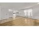 Bright living area with wood floors, white walls and view to other parts of the house at 12107 E Vassar Dr, Aurora, CO 80014