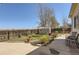 Spacious backyard featuring lush grass, mature trees, and a charming storage shed at 1141 Beech St, Fort Lupton, CO 80621