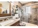 Updated bathroom featuring a granite vanity, tiled shower, and modern fixtures at 1141 Beech St, Fort Lupton, CO 80621