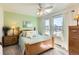 Bright bedroom with natural light, light green walls, and a ceiling fan above the bed at 1141 Beech St, Fort Lupton, CO 80621