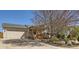 Charming home featuring a garage, covered porch, and well-maintained landscaping with a beautiful mature tree at 1141 Beech St, Fort Lupton, CO 80621