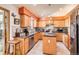Spacious kitchen with warm wood cabinets, dark countertops, and stainless steel appliances, offering ample storage at 1141 Beech St, Fort Lupton, CO 80621
