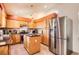 Bright kitchen with stainless steel appliances, central island, and lots of cabinet space at 1141 Beech St, Fort Lupton, CO 80621