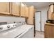 Functional laundry room equipped with a washer, dryer, and ample cabinet space at 1141 Beech St, Fort Lupton, CO 80621