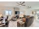 Comfortable living room featuring a stone fireplace, ample seating, and natural light at 1141 Beech St, Fort Lupton, CO 80621