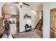 Bright living room featuring archway, hardwood floors, staircase, and seamlessly connects to the kitchen and dining area at 1141 Beech St, Fort Lupton, CO 80621