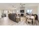 Open-concept living room with fireplace, ceiling fans, and sliding doors to the outside at 1141 Beech St, Fort Lupton, CO 80621