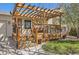 Inviting covered porch with wooden pergola, comfortable seating, and tasteful outdoor decor create a welcoming space at 1141 Beech St, Fort Lupton, CO 80621