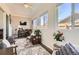Inviting sunroom with ample natural light, cozy seating, and stylish decor at 1141 Beech St, Fort Lupton, CO 80621