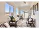Bright sunroom with large windows, comfortable seating, and views of the surrounding landscape at 1141 Beech St, Fort Lupton, CO 80621