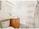 Bright bathroom featuring a shower-tub combo, single sink vanity and a large mirror with vanity lighting at 1243 N Washington St # 108, Denver, CO 80203