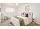 Cozy bedroom with a ceiling fan, comfortable queen size bed and a glass desk by a window at 1243 N Washington St # 108, Denver, CO 80203