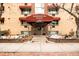 Attractive brick building entrance with awning displaying 'Washington Place 1243' and snow-dusted landscaping at 1243 N Washington St # 108, Denver, CO 80203