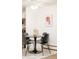 Cozy dining area with a round table, black chairs, and a contemporary light fixture at 1243 N Washington St # 108, Denver, CO 80203