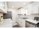 Well-lit kitchen featuring stainless steel appliances, tile backsplash, and marble countertops at 1243 N Washington St # 108, Denver, CO 80203