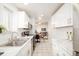 Bright kitchen featuring ample white cabinetry, marble countertops, and an open view to the living area at 1243 N Washington St # 108, Denver, CO 80203