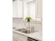 Close up of the kitchen sink area with stainless steel fixtures and natural light at 1243 N Washington St # 108, Denver, CO 80203