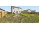 Spacious backyard featuring grass, a patio, and an outdoor dining set at 1063 Gianna Ave, Fort Lupton, CO 80621