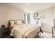 Comfortable bedroom with a large window and a bed with a floral comforter at 1063 Gianna Ave, Fort Lupton, CO 80621