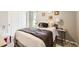 Cozy bedroom with a decorative pillow, neutral color scheme, and closet space at 1063 Gianna Ave, Fort Lupton, CO 80621
