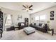 Bright living room with a ceiling fan and multiple windows offering plenty of natural light at 1063 Gianna Ave, Fort Lupton, CO 80621