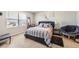 Cozy main bedroom featuring a large window, comfortable bed, and stylish decor at 1063 Gianna Ave, Fort Lupton, CO 80621