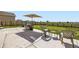 Outdoor patio with a dining set, chairs, and a garden view at 1063 Gianna Ave, Fort Lupton, CO 80621