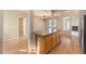 Bright kitchen featuring wood floors, ample cabinet space, and a view of the living area at 17086 E 106Th Ave, Commerce City, CO 80022