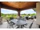 Back porch has a large table to seat six people offering views of nature and neighborhood homes at 12775 Horizon Trl, Castle Pines, CO 80108