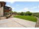 Sprawling green backyard featuring a stone patio and covered deck at 12775 Horizon Trl, Castle Pines, CO 80108