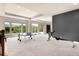 A large basement area with a ping pong table, a bar, and multiple windows at 12775 Horizon Trl, Castle Pines, CO 80108